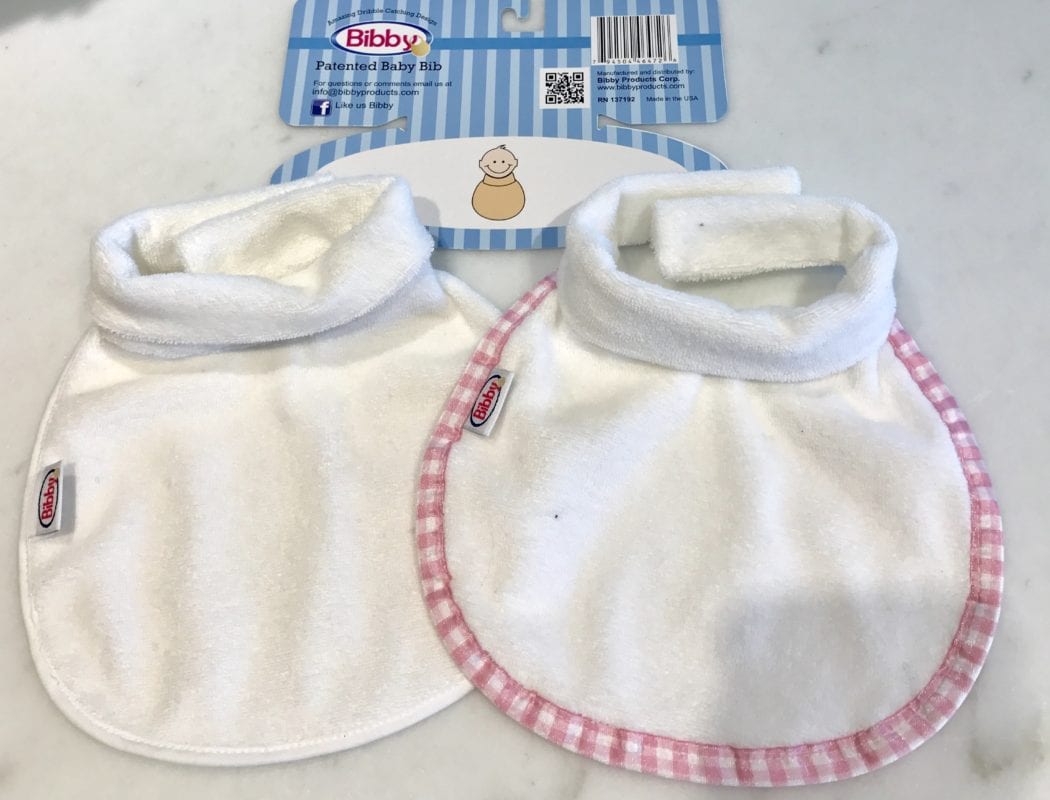 Two different colors of Bibby bibs - the patented baby bib with a collar