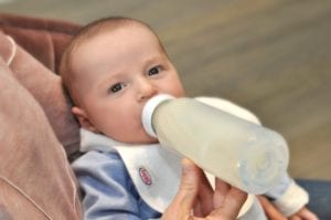 baby being bottle fed with our collared Bibby bib